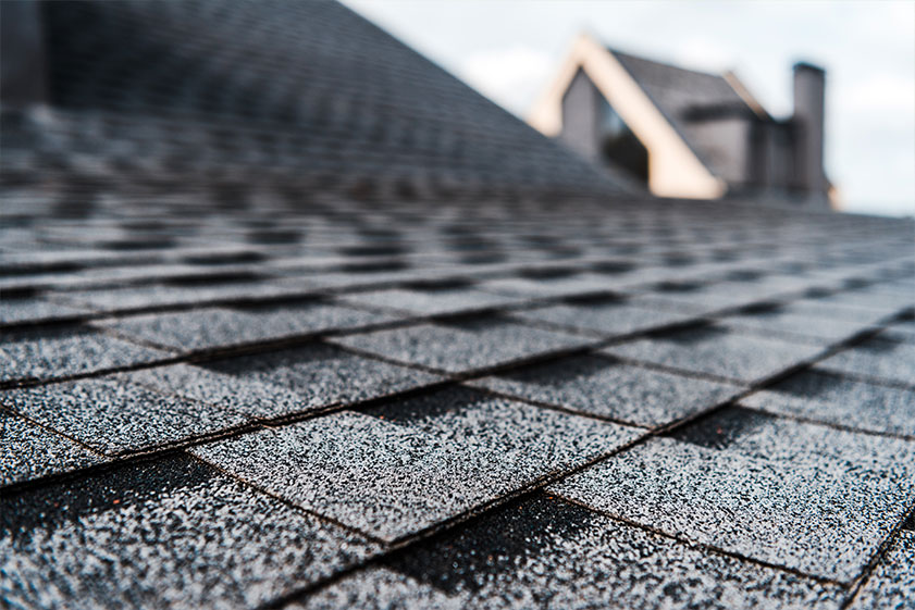 Selective focus of grey shingles on rooftop